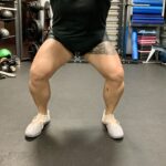 Someone squatting with a medium stance