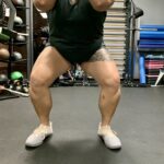 Someone squatting with feet slightly turned out