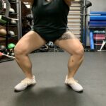 Someone squatting with feet turned out